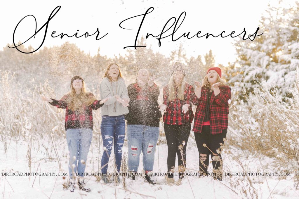 High School Senior Portraits in the snow wearing buffalo plaid checkered outfits with snow on trees at sunset taken near Lincoln, Nebraska. Nebraska Senior Pictures.