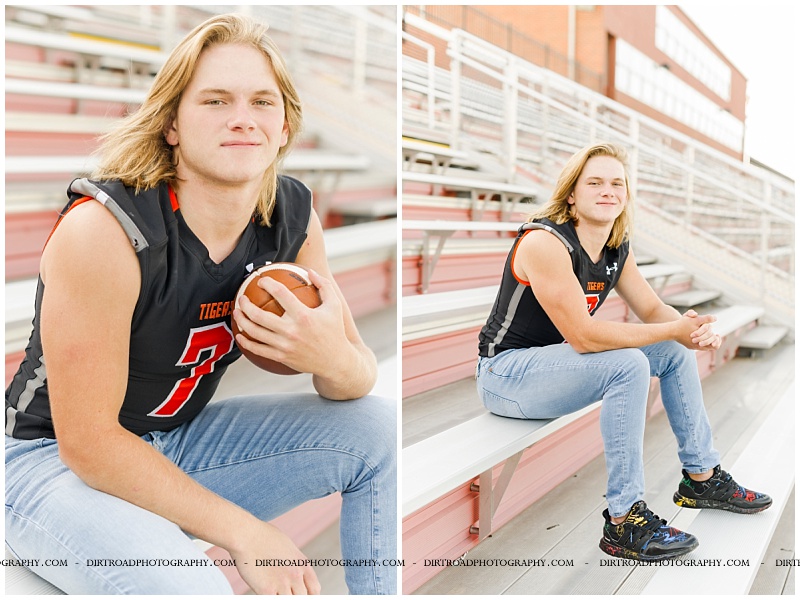 senior picture of boy holding football wearing jersey sitting on stadium bleachers. senior guy is wearing football jersey with jeans and tennis shoes with long blond hair with sunset. hastings high school. nebraska senior photographer located near lincoln, nebraska.