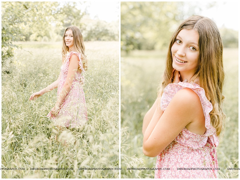 fairbury nebraska senior pictures of madison at pioneers park in lincoln, nebraska. girl standing in tall green grass with pink dress on in the summer. dirt road photography.