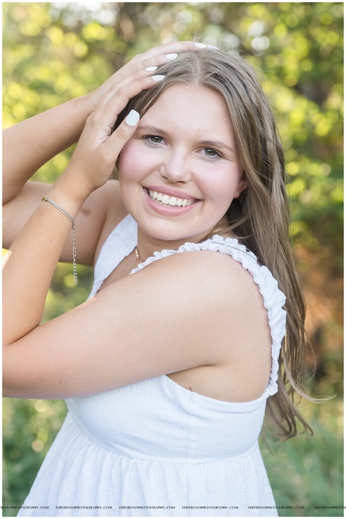 Outdoor senior photos of Waverly senior Esther VanOverbeke in a rural field with natural light.